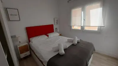 a bedroom with a bed with towels on it at LA VICTORIA in Cádiz