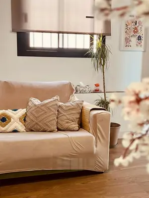 a couch with pillows in a living room at Loft céntrico con gran terraza in El Puerto de Santa María