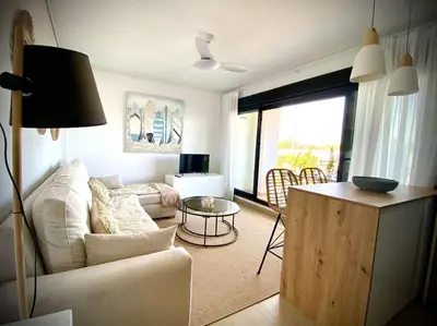 a living room with a couch and a table at MyChoice Terraces in Rota