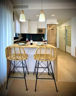 a kitchen with two bar stools and a counter top at MyChoice Terraces in Rota