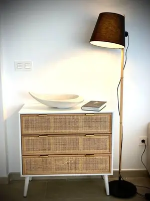 a table with a lamp and a plate on top of a dresser at MyChoice Terraces in Rota