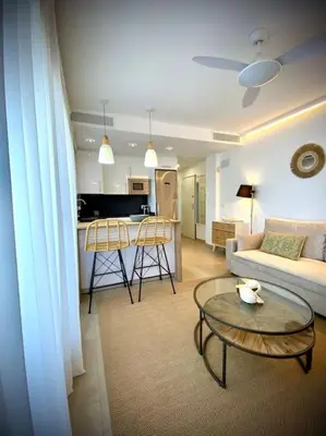 a living room with a couch and a table at MyChoice Terraces in Rota