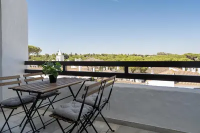 a table and chairs on a balcony with a view at Apartoyou - Vistahermosa in El Puerto de Santa María