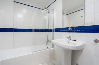 a white bathroom with a sink and a shower at Apartoyou - Vistahermosa in El Puerto de Santa María