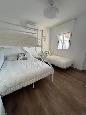 two bunk beds in a room with wooden floors at Villa Armonía in Arcos de la Frontera