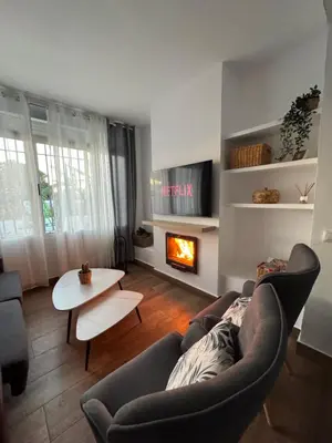 a living room with a couch and a fireplace at Villa Armonía in Arcos de la Frontera