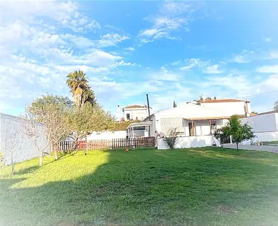 a house with a fence and a yard with a grass yard at Villa Armonía in Arcos de la Frontera