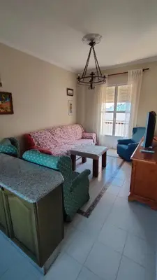 a living room with a couch and a table at Casa Las Vidrieras in Puerto Real