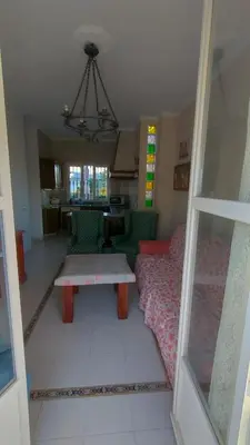 a living room with a couch and a table at Casa Las Vidrieras in Puerto Real
