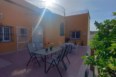 a patio with a table and chairs on a building at Casa Las Vidrieras in Puerto Real