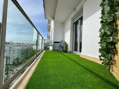 a balcony with green grass on a building at Skyline - Loft with private terrace and breathtaking views! in Cádiz