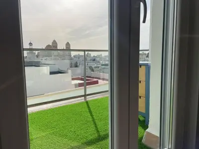 a window with a view of the green grass at Skyline - Loft with private terrace and breathtaking views! in Cádiz