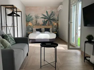 a living room with a bed and a couch at Skyline - Loft with private terrace and breathtaking views! in Cádiz