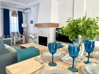 a dining room table with blue wine glasses on it at Villa Mar in Chiclana de la Frontera