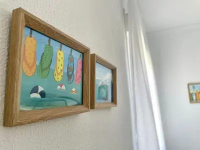 two framed pictures of food hanging on a wall at Villa Mar in Chiclana de la Frontera