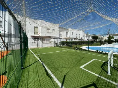 a tennis court in front of a house at Villa Mar in Chiclana de la Frontera