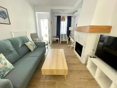a living room with a couch and a coffee table at Villa Mar in Chiclana de la Frontera