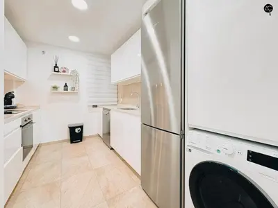 a kitchen with a refrigerator and a dishwasher at El Encanto de la Playa Santa Mª Grupo AC Gestion in Cádiz
