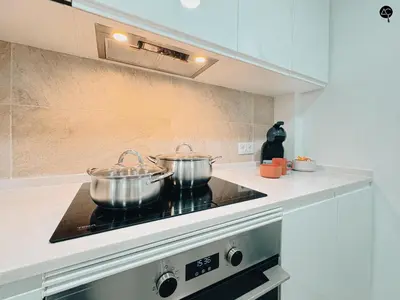 two pots on top of a stove in a kitchen at El Encanto de la Playa Santa Mª Grupo AC Gestion in Cádiz