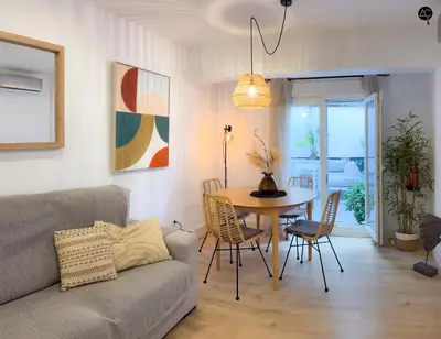 a living room with a couch and a table at El Encanto de la Playa Santa Mª Grupo AC Gestion in Cádiz