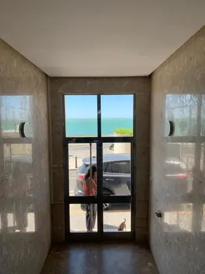 a room with a door with a view of a car in a parking lot at El Encanto de la Playa Santa Mª Grupo AC Gestion in Cádiz