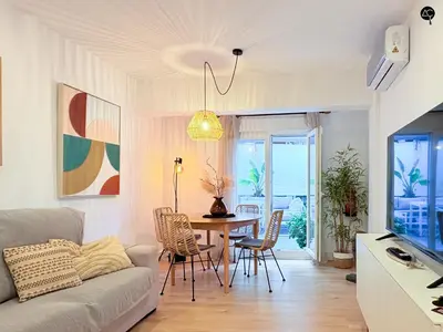 a living room with a couch and a table at El Encanto de la Playa Santa Mª Grupo AC Gestion in Cádiz