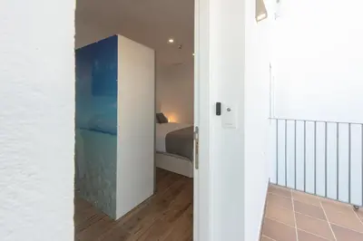 a room with a bed and a room with a hallway at Apartamentos Santa María 15 in Jerez de la Frontera