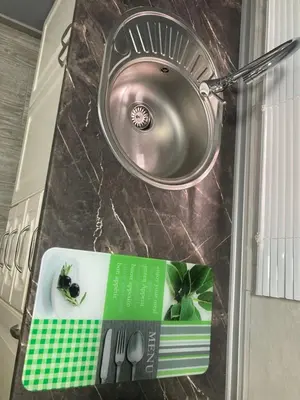 a kitchen counter with a sink and a book on it at Villa Mutt in Jerez de la Frontera