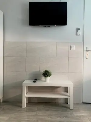 a white table with a tv on a wall at Villa Mutt in Jerez de la Frontera