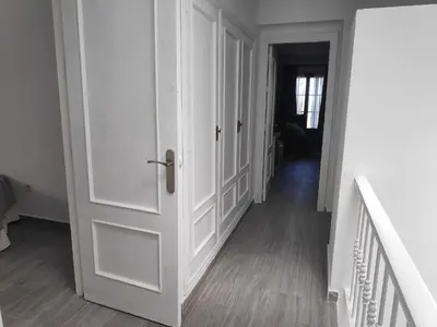 a hallway with a white door and a staircase at Sonsoles Apartamentos Bahía Sur in San Fernando
