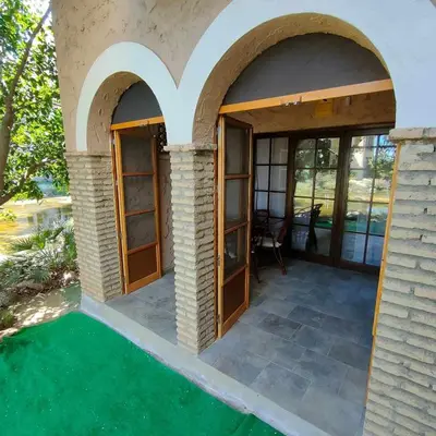 a house with two arched doors and a patio at Sonsoles Apartamentos Bahía Sur in San Fernando