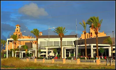 a group of people walking in front of a building at Sonsoles Apartamentos Bahía Sur in San Fernando
