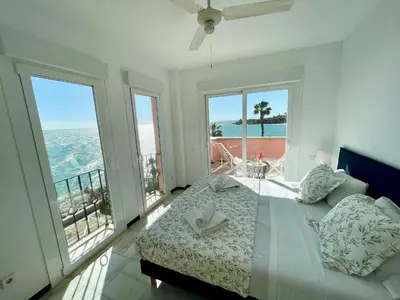 a bedroom with a bed and views of the ocean at GATU Villa Océano frente al mar en Puerto Sherry 
