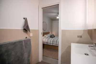 a bathroom with a sink and a bedroom with a bed at Arenas de Sanlúcar II in Sanlúcar de Barrameda