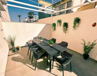 a black table and chairs on a patio at Arenas de Sanlúcar II in Sanlúcar de Barrameda