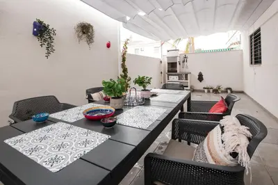 a dining room with a black table and chairs at Arenas de Sanlúcar II in Sanlúcar de Barrameda