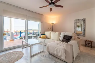 a living room with a couch and a ceiling fan at Top Ático Estudio Sur - Terraza in Jerez de la Frontera