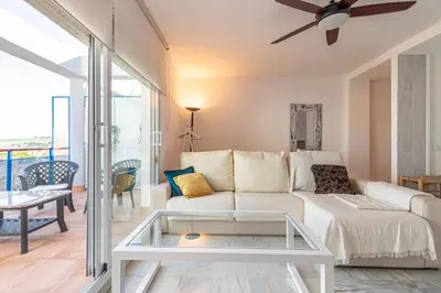 a living room with a white couch and a glass table at Top Ático Estudio Sur - Terraza in Jerez de la Frontera