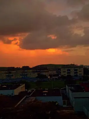 a sunset over a city with buildings and a sky at Top Ático Estudio Sur - Terraza in Jerez de la Frontera