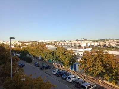 a city street with cars parked in a parking lot at Top Ático Estudio Sur - Terraza in Jerez de la Frontera