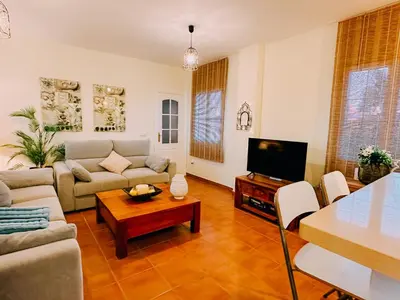 a living room with a couch and a table at Mika's House Pool in Sanlúcar de Barrameda