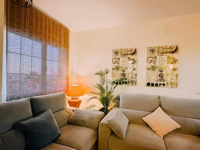 a living room with a couch and a window at Mika's House Pool in Sanlúcar de Barrameda
