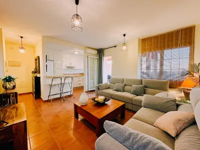 a living room with two couches and a table at Mika's House Pool in Sanlúcar de Barrameda