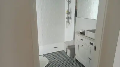 a white bathroom with a toilet and a sink at Diseño y luz entre los pinos in Chiclana de la Frontera
