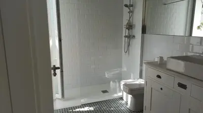 a bathroom with a shower and a toilet and a sink at Diseño y luz entre los pinos in Chiclana de la Frontera