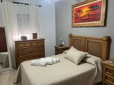 a bedroom with a bed with two pillows on it at Casa Inés in Sanlúcar de Barrameda