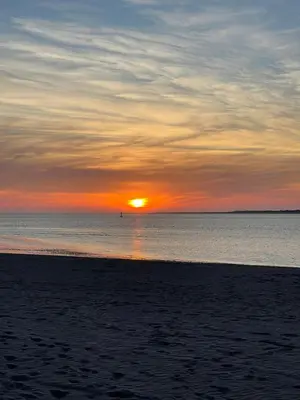 a sunset on the beach with the sun setting at Casa Inés in Sanlúcar de Barrameda