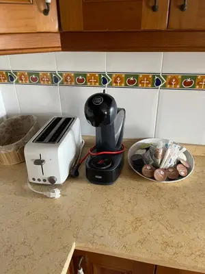 a toaster sitting on a counter next to a bowl of food at Casa Inés in Sanlúcar de Barrameda