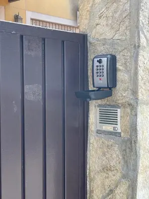 a door with a pay phone on a stone wall at Casa Inés in Sanlúcar de Barrameda