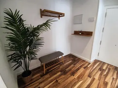 a room with a bench and a potted plant at La Playita Santa María Beach in Cádiz